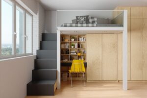 A small room with a loft bed, desk, and chair, designed to make the most of limited space.