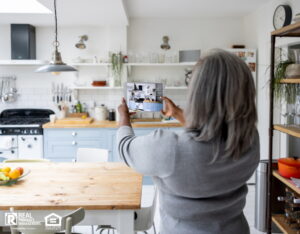 Woman taking pictures and video of rental house using a tablet computer.