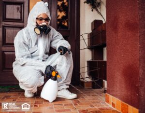 A pest control expert treating the inside of a home.