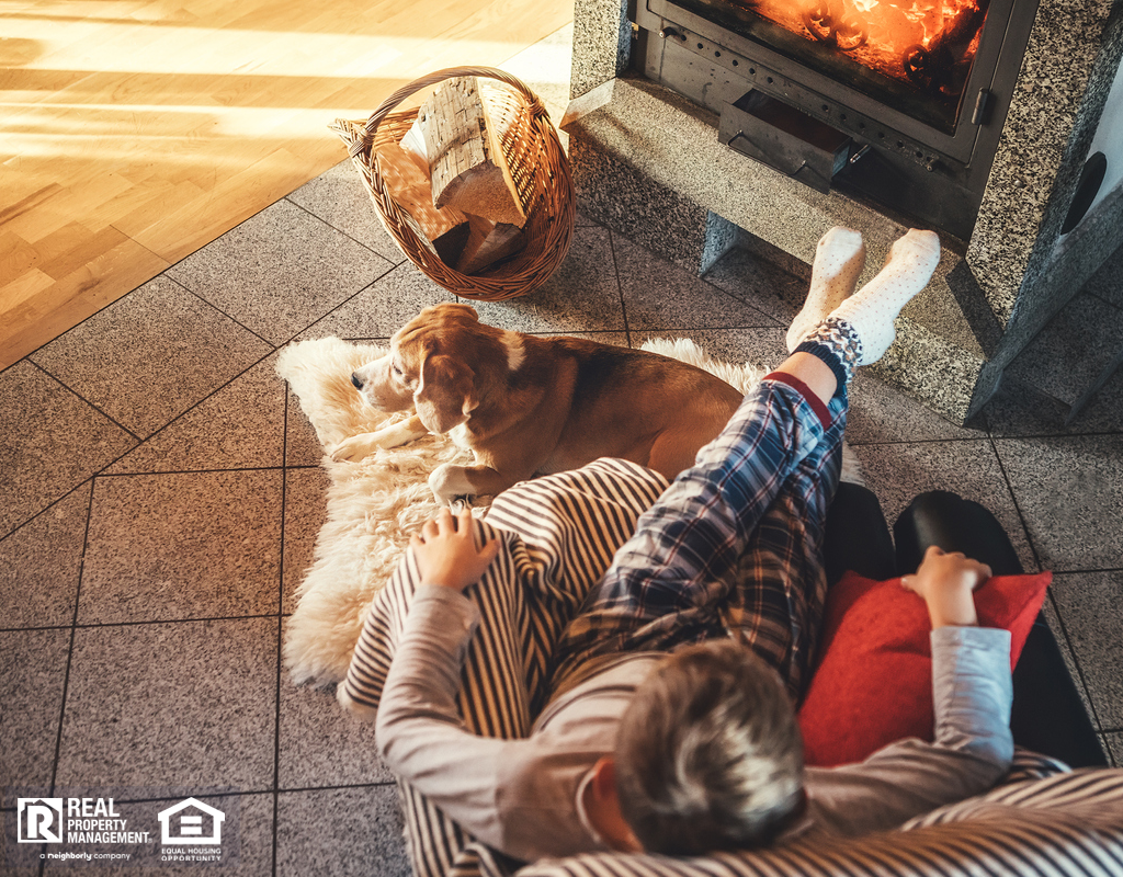 Child and Dog Sitting in Front of Fireplace in Cozy Living Room During Fall