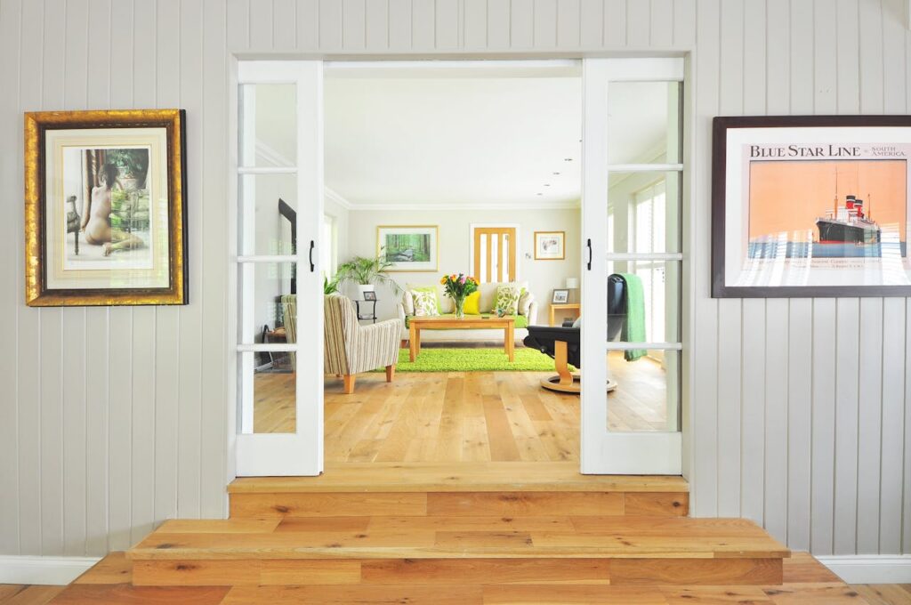 doorway looking into white living room with green rug