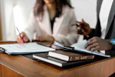 Two-lawyers-reviewing-documents-with-law-books-on-a-desk.-Professional-legal-environment.jpg