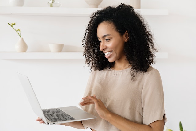 person-standing-typing-with-one-hand-on-computer