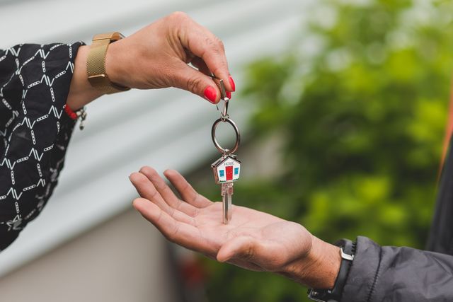 people exchanging house keys