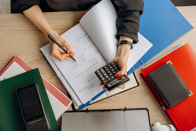 person with a calculator taking notes
