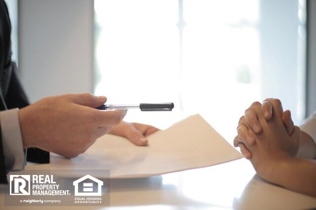 Banker passing paperwork and pen for investor to sign