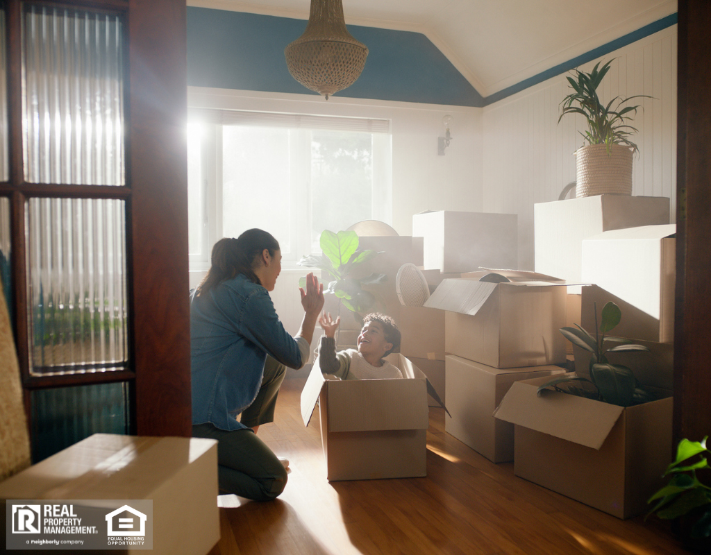 Son and mother high five in new home with boxes.