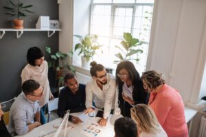 People collaborating at a table, focused on real estate crowdfunding project ideas.