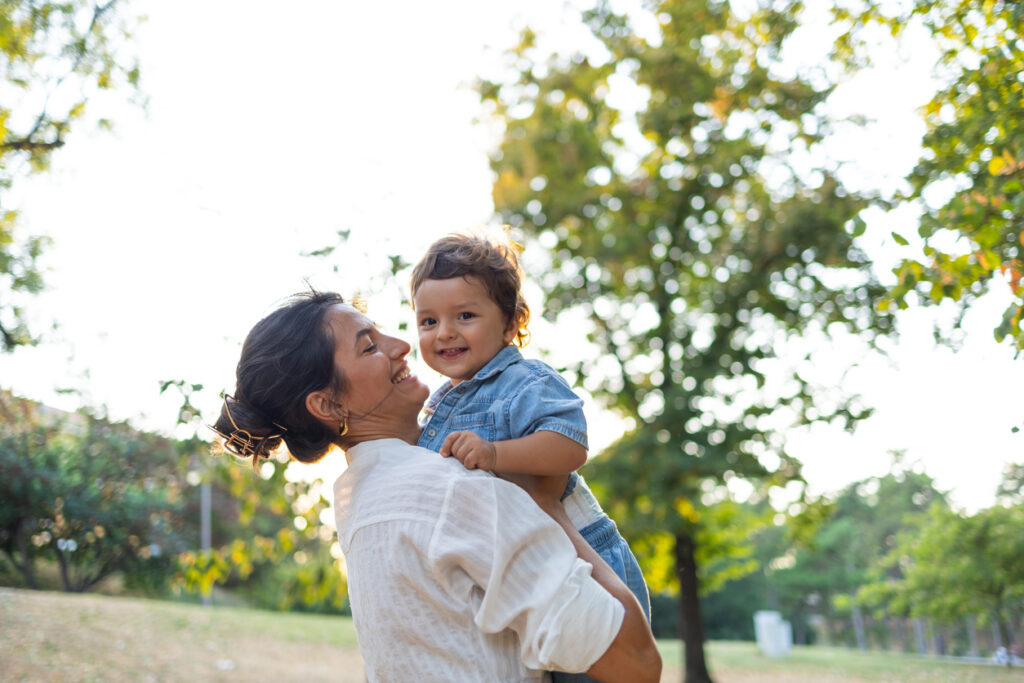 Joyful mother lifting child
