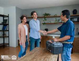 Homeowners shaking hands with a contractor in a cozy home setting.