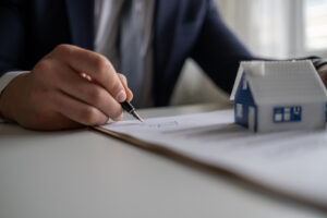 Resident signing a lease agreement contract to rent a home.
