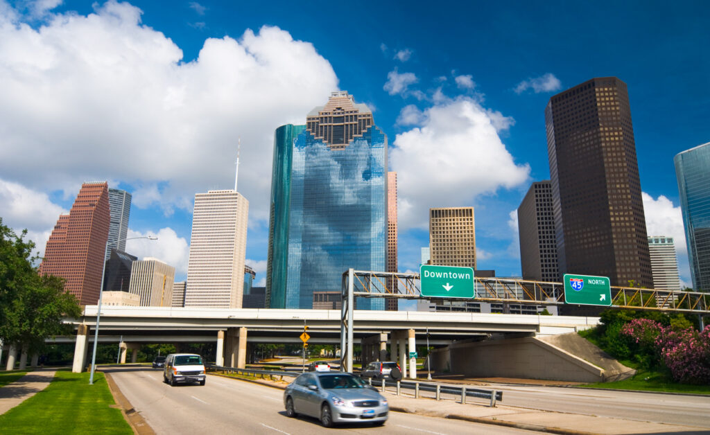 Allen Parkway, several cars, and I-45 overpass in the foreground.