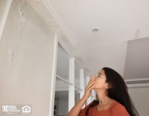 A woman sees the results of a bad property renovation.