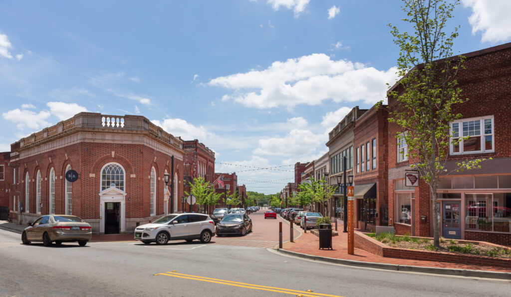 Intersection of Poinsett and Trade Street, showing Barista Alley building.