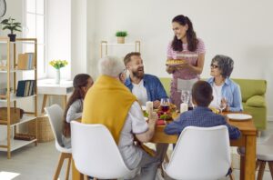 Multi-generational family is celebrating at festive table with delicious food.