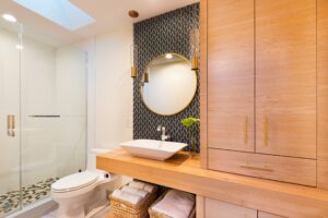 A clean bathroom featuring a sink, toilet, and a shower, all in a modern design.