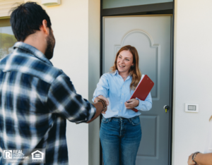 A happy property manager greets a tenant at the door.