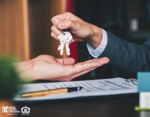 Agent Handing Property Investor Keys After Purchase