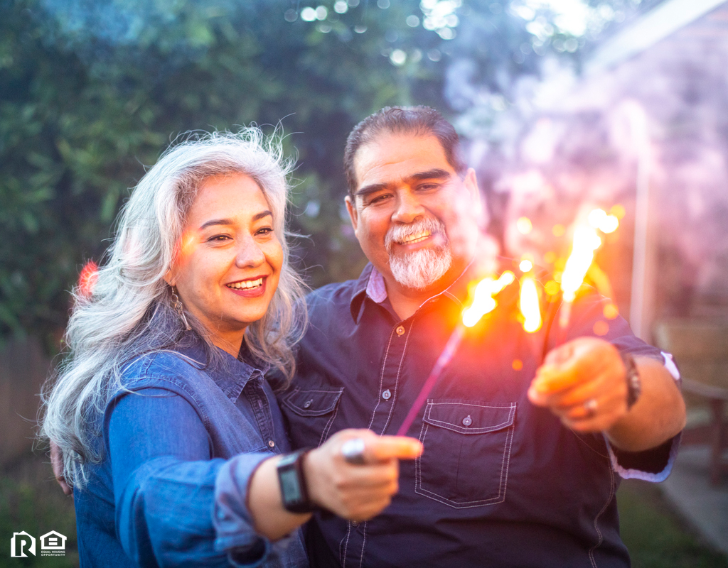 Windermere Couple Holding Sparklers Together