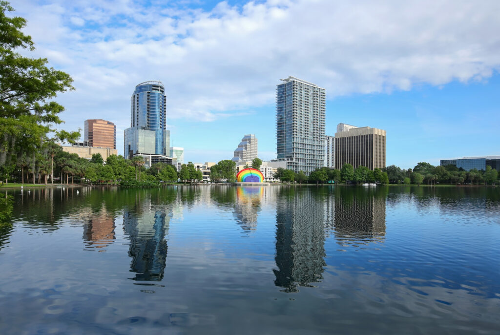 Downtown Orlando skyline glistens as it reflects in the clean waters of Lake Eola, a popular downtown tourist attraction.