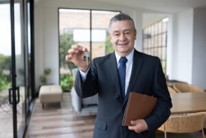 Real estate agent holding the keys of a house for sale