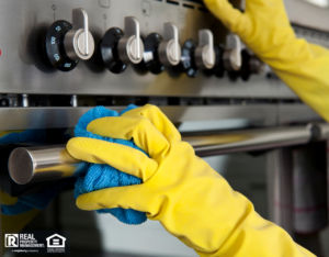 Person Scrubbing Oven with Rubber Gloves