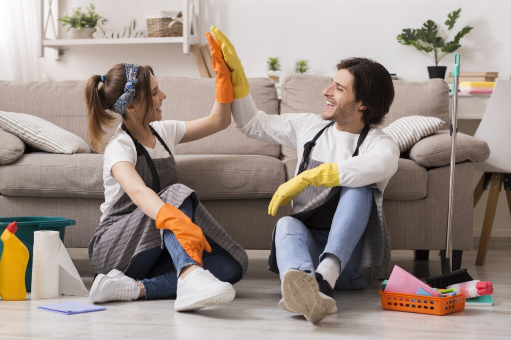 A happy couple cleaning up their rental property and keeping it tidy