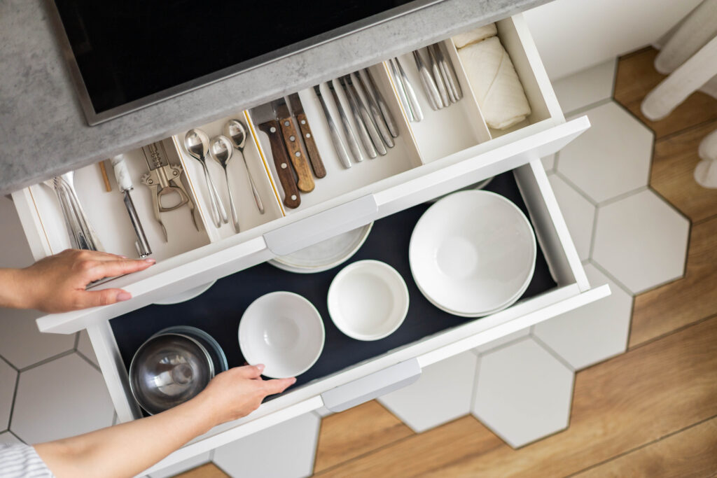 Well-organized kitchen items in a drawer of a tidy kitchen