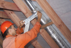 Weather stripping being added to windows as part of the winterizing process in a rental property. 