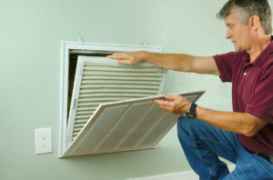 Leander Homeowner Replacing Air Filter on Their Air Conditioner