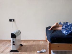Georgetown Resident Warming Their Feet with a Space Heater