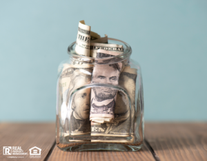 Mason Jar with Several Dollar Bills Stuffed Inside as an Emergency Fund
