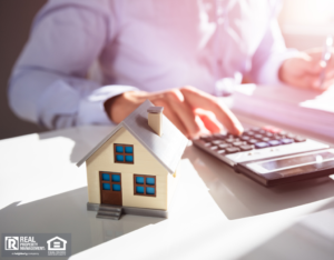 Businessperson Calculating Property Taxes on Calculator