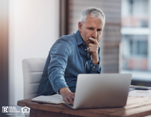 Round Rock Property Manager Looking Thoughtfully at His Laptop