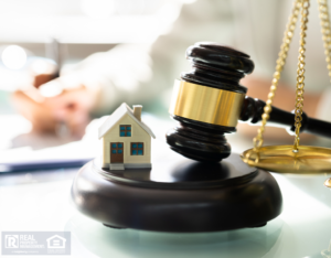A Scale Next to a Model House and Gavel