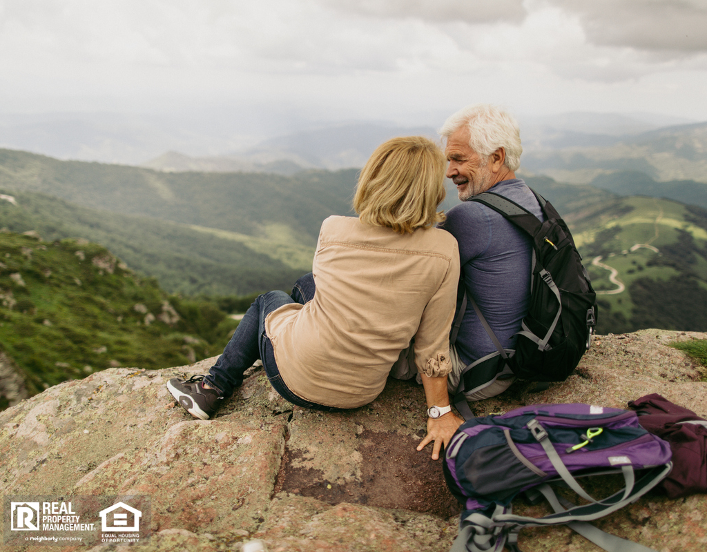 Older Couple Resting During Hike with Backpacks