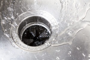 Sink with Water Flowing Down into a Garbage Disposal