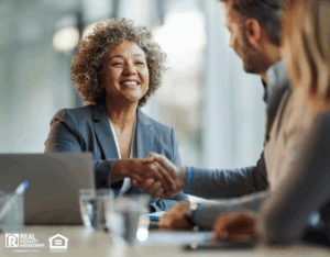 Insurance agent closing deal with real estate professionals with a handshake.